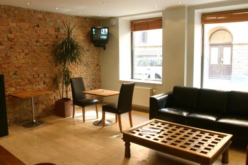a living room with a couch and a table at Rex Hotel in Stockholm