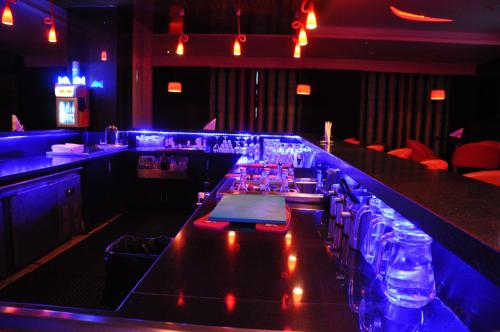 a bar with a long counter in a restaurant at Gokulam Park Coimbatore in Coimbatore