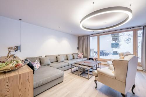 a living room with a couch and a table at Bühlhof Appartements in Lech am Arlberg