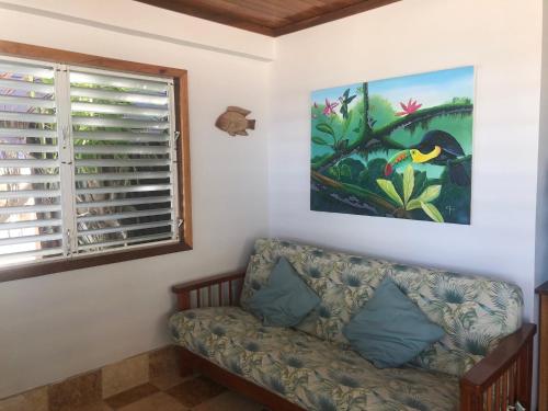 a living room with a couch and a window at Colinda Cabanas in Caye Caulker
