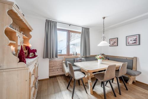 a dining room with a table and chairs at Bühlhof Appartements in Lech am Arlberg