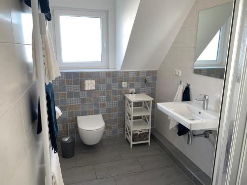 a bathroom with a sink and a toilet and a window at Heidewohnung in Soltau