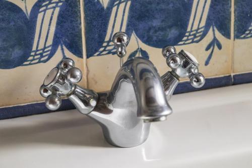 a bathroom sink with a faucet on a sink at Son Niu Vell-La Hermossa in Valldemossa