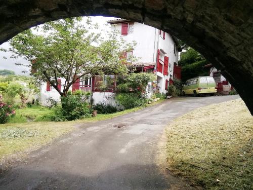 a view of a road through an arch in a building at Studio le moulin de Pascale in Espelette