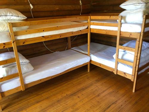 a room with three bunk beds in a cabin at Lane Loge in Uddevalla