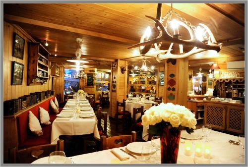 a dining room with tables with white tablecloths at Hôtel Saint-Georges in Megève