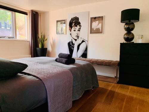 a bedroom with a picture of a woman on the wall at Houseboat-Amsterdam in Amsterdam