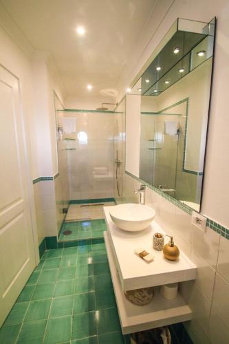 a bathroom with a sink and a mirror at Casa Pesce in Ponza