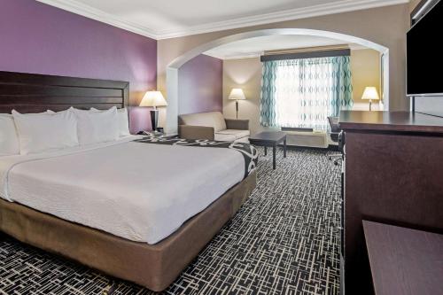 a hotel room with a large bed and a desk at La Quinta by Wyndham Temecula in Temecula