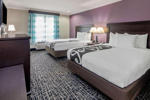 a hotel room with two beds and a window at La Quinta by Wyndham Temecula in Temecula
