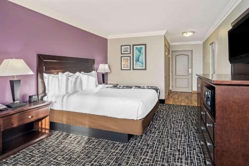 a hotel room with a bed and a television at La Quinta by Wyndham Temecula in Temecula