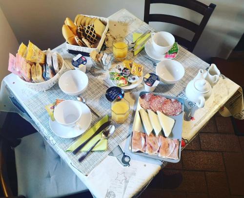 a table with breakfast foods and drinks on it at Montechiari In Chianti in Greve in Chianti