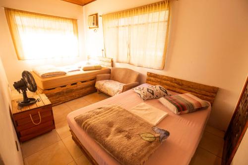 a small bedroom with a bed and a window at Ecohostel Dos Canyons Santa Catarina in Praia Grande