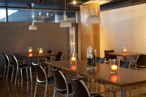 a room with a table and chairs with lit candles at Centro Hotel Turku in Turku