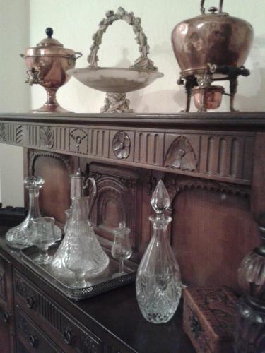a table with several glass vases on top of it at The Post House in Ibstock