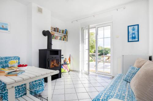 a living room with a fireplace and a couch at Regatta in Chłopy