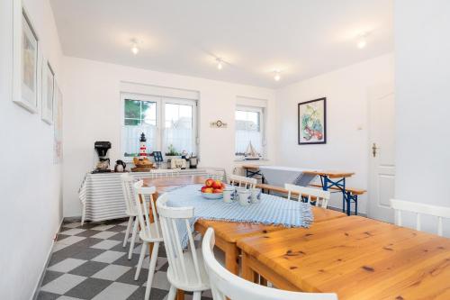 a kitchen and dining room with a wooden table and chairs at Regatta in Chłopy