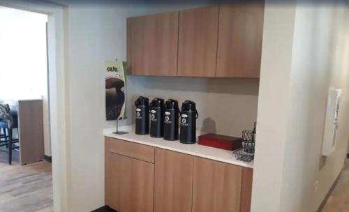 a kitchen with a counter with four bottles on it at Microtel Inn & Suites by Wyndham Woodland Park in Woodland Park