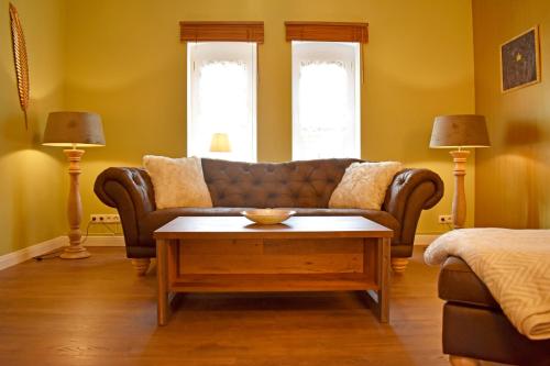 a living room with a couch and a coffee table at Stangenberg`s Dachschlösschen in Hameln