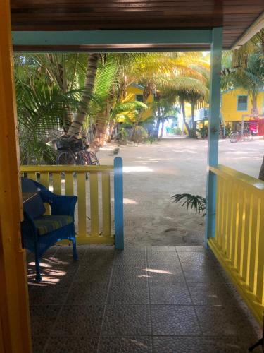 an open door to a porch with a bench at Colinda Cabanas in Caye Caulker
