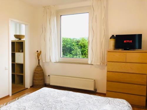 a bedroom with a bed and a window at Haus Graf Velden in Velden am Wörthersee