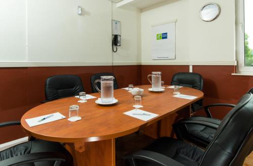 a conference room with a wooden table and chairs at Holiday Inn Express Burton on Trent by IHG in Burton upon Trent