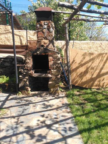 a stone oven in a yard with a fence at An'Ca' La Pura in Villanueva del Conde