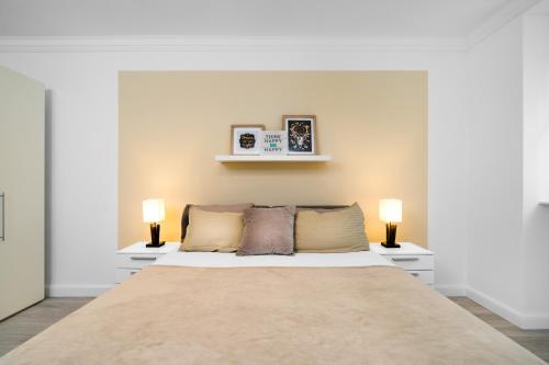 - une chambre avec un grand lit et deux lampes dans l'établissement GreatStay Lachmannstr. 3, à Berlin