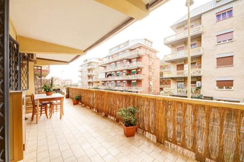 a balcony with a table and chairs and some buildings at Mare di Roma in Lido di Ostia