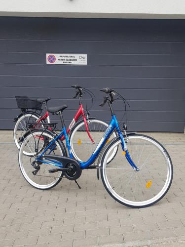 two bikes parked in front of a building at ONE Luxury Suites Eger in Eger
