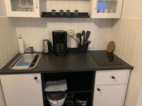 a kitchen with a black counter top and a sink at Villa Västanede in Västanede