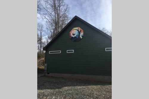 a black garage with a round window on it at Serenity Views Comfort - Close to City & Parkway! in Weaverville
