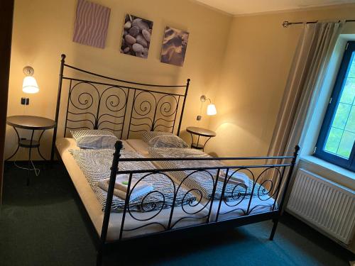 a bedroom with a black bed in a room at Apartments Merlin in Mariánské Lázně