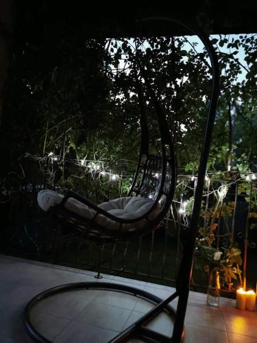 a hammock sitting on top of a patio at Casa File de Poveste in Târgu Jiu