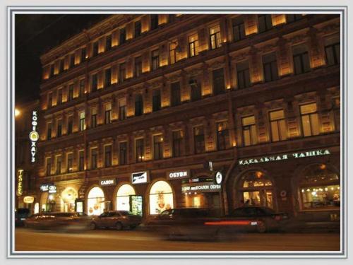 a large building on a city street at night at Butterfly in Saint Petersburg