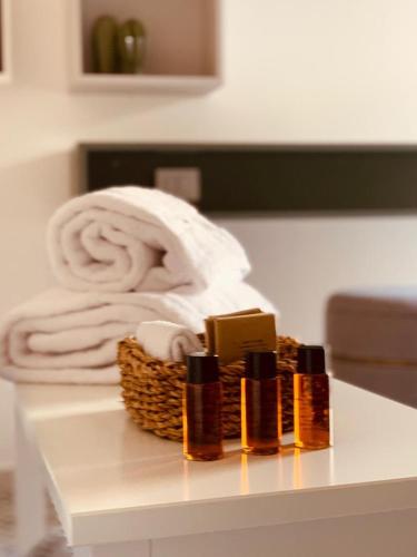 a basket of soap and towels on a table at Carlo Alberto Room in Fasano