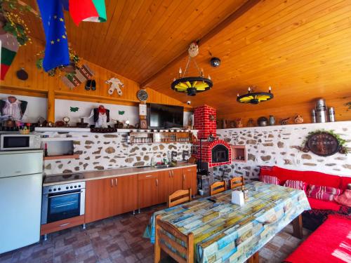 a kitchen with a table and a counter top at Guest House Dorkos in Dorkovo