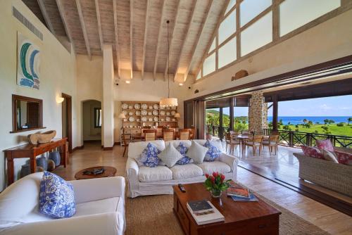 a living room with a couch and a table at Canouan Estate Resort & Villas in Canouan