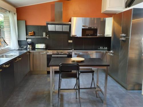 eine Küche mit einem Tisch und 2 Stühlen in der Unterkunft Le Loft in Aulnay-sous-Bois