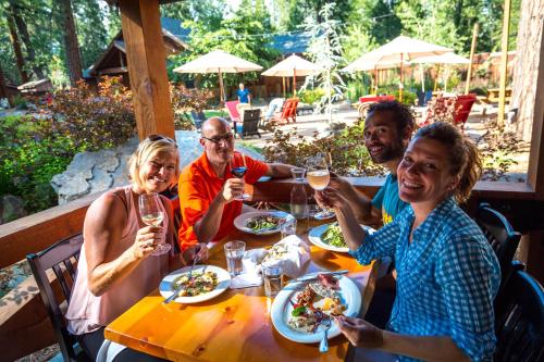 a group of people sitting at a table with wine glasses at Evergreen Lodge at Yosemite in Groveland