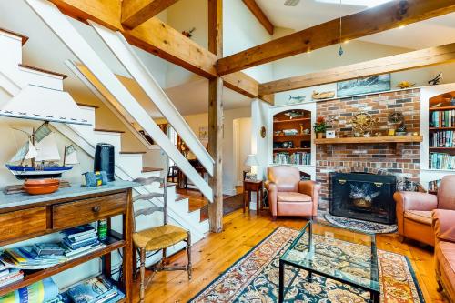 a living room with a fireplace and a brick wall at Paradise On Cape Cod in Orleans