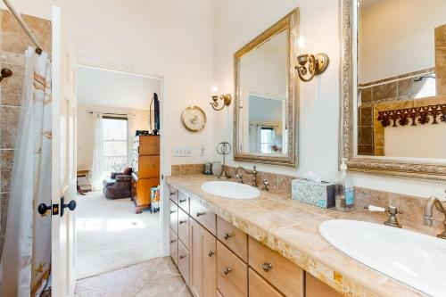 a bathroom with two sinks and a mirror at Paradise On Cape Cod in Orleans