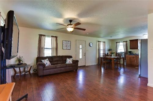 a living room with a couch and a ceiling fan at Austin Escape in Cedar Creek