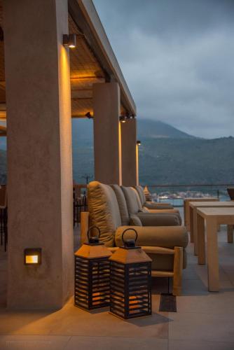 a row of couches and tables on a balcony at Brazzo di Maina in Oítilon