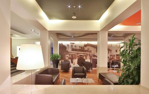 a lobby with couches and chairs and a table at Best Western Plus Hotel Bologna in Mestre