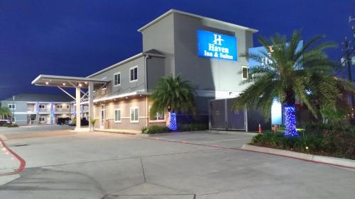 a hotel with a sign on the front of it at Haven Inn & Suites Downtown Houston. in Houston