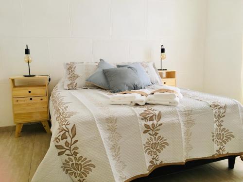 a bedroom with a bed with two towels on it at DLA Apartamentos III in Villa María