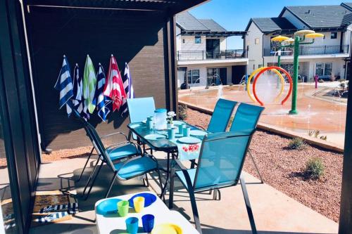 a patio with a table and chairs and a playground at Kantada in the Sun - Poolside Retreat in Santa Clara