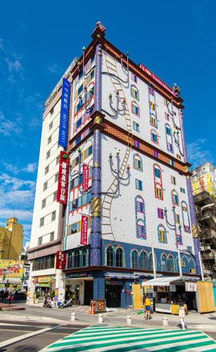 a large building with a mural on the side of it at Norway Forest Travel hotel 1 Taichung in Taichung