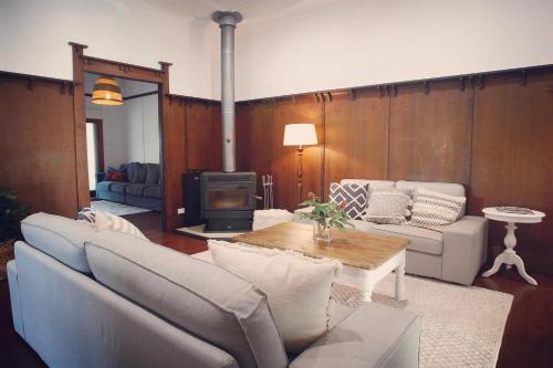 a living room with a couch and a table at The Belle Riverhouse, Tumbulgum# in Tumbulgum